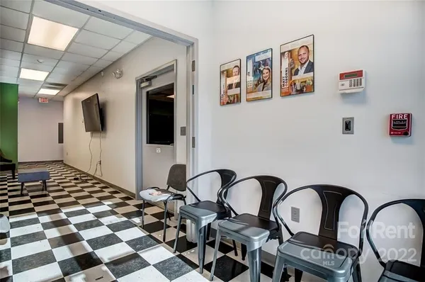 a black and white checkered floor with a rug