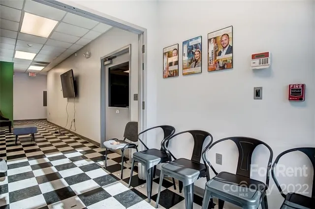 a black and white checkered floor with a rug