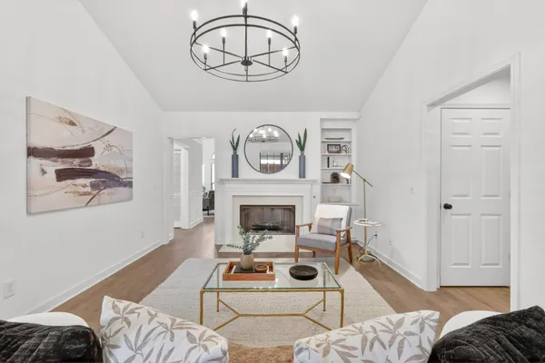 a kitchen with kitchen island white cabinets and white appliances