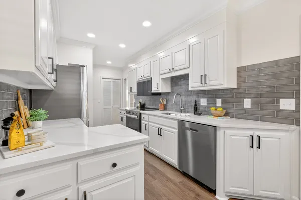a kitchen with a sink a stove and refrigerator