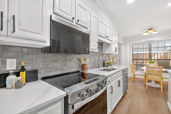 a kitchen with a refrigerator and a sink