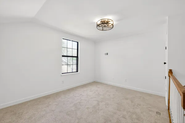 a view of an empty room with stairs