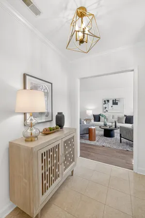 a living room with furniture a lamp and a potted plant