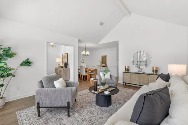 a living room with furniture and a lamp