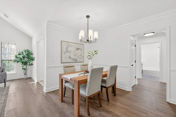 a living room with furniture chandelier and a rug