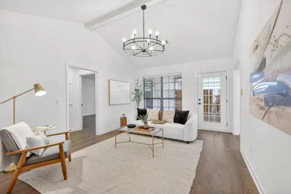 a living room with furniture and a large window