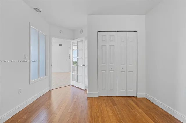 a view of an empty room and wooden floor