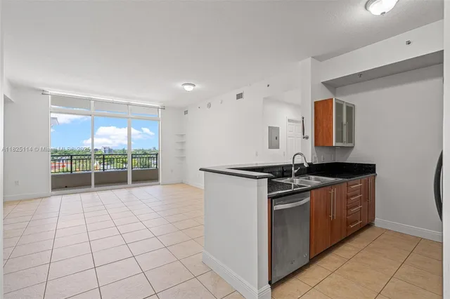 a kitchen with stainless steel appliances granite countertop a stove and a sink