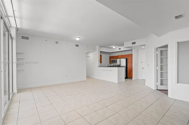 an empty room with a fireplace and cabinet