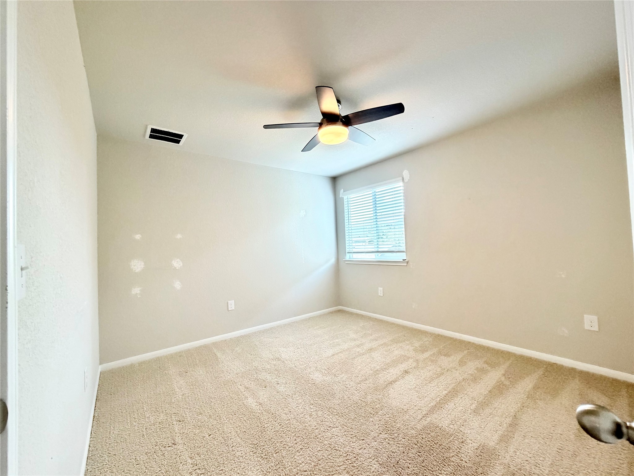 10502 Fulton Avenue Austin, TX 78754 - Photo 24 of 36 An inviting room with plush carpeting and natural light, perfect for a cozy retreat.
