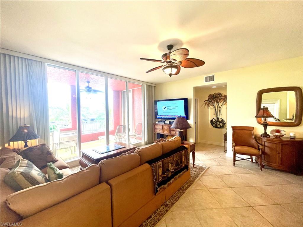 451 Bayfront Place, Unit 5311 Naples, FL 34102 - Photo 8 of 38 a living room with furniture a flat screen tv and a large window