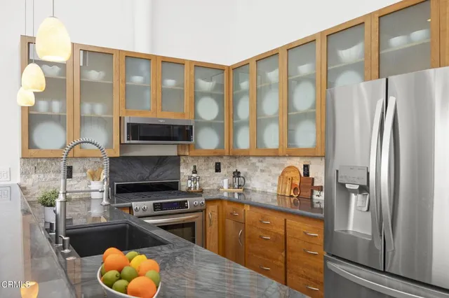 a kitchen with stainless steel appliances a stove and a refrigerator