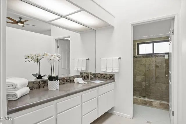 a bathroom with double sink and a mirror