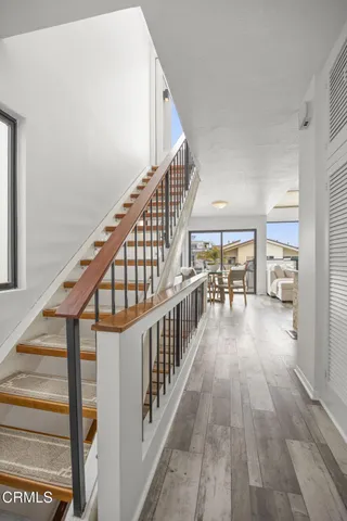 a view of staircase with wooden floor and a window