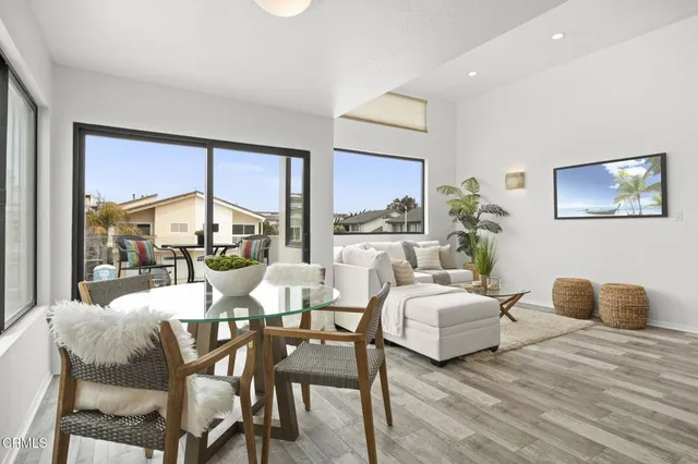 a dining room with furniture and a large window