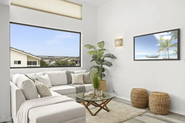 a living room with furniture and a painting