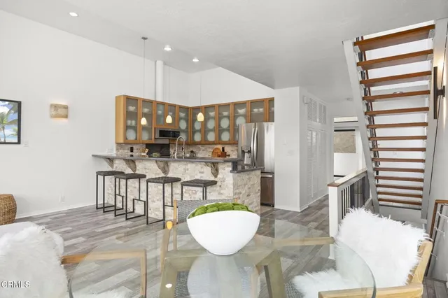 a living room with kitchen island furniture and a wooden floor