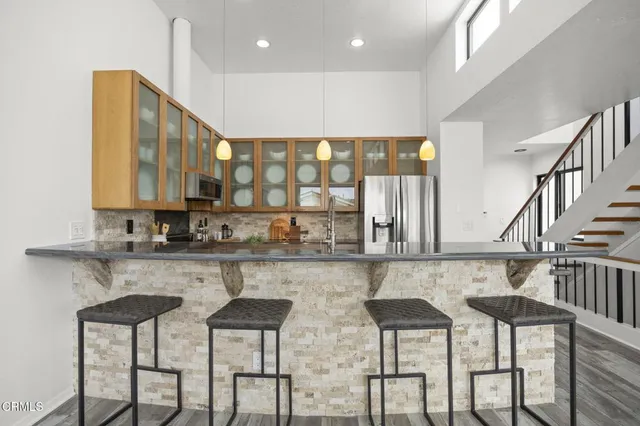a kitchen with lots of counter space and chairs in it