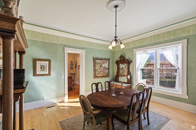 390 North 100 West Monroe, UT 84754 - Photo 15 of 167 Dining area featuring light wood-style floors, crown molding, and a chandelier