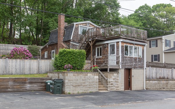 a front view of a house with a garden
