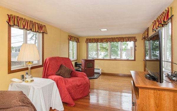 89 Lake Attitash Road Amesbury, MA 01913 - Photo 12 of 29 a bedroom with a large bed and a large window