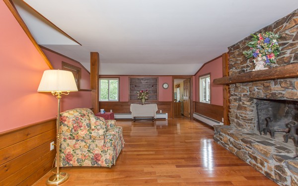 89 Lake Attitash Road Amesbury, MA 01913 - Photo 14 of 29 a living room with furniture and a fireplace