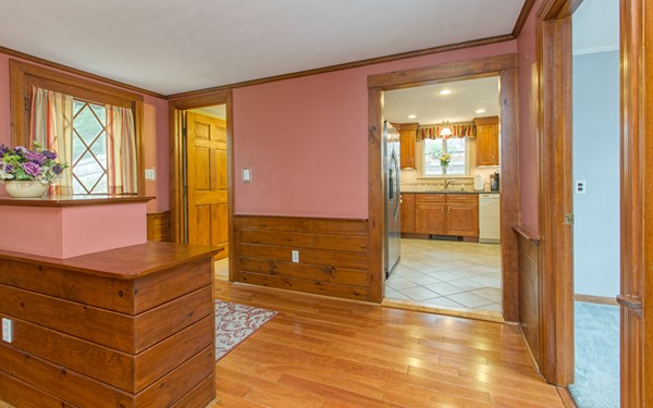 89 Lake Attitash Road Amesbury, MA 01913 - Photo 16 of 29 a view of kitchen with wooden floor and a flat screen tv