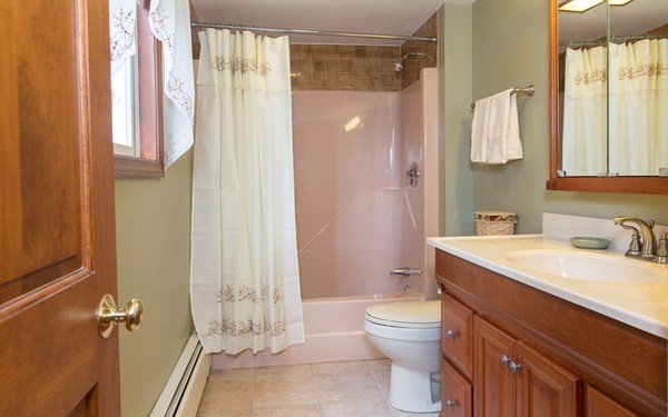 89 Lake Attitash Road Amesbury, MA 01913 - Photo 17 of 29 a bathroom with a sink a toilet and shower