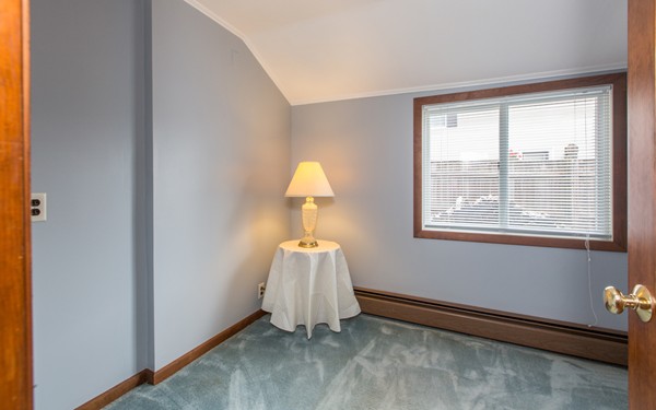 89 Lake Attitash Road Amesbury, MA 01913 - Photo 18 of 29 a room with a window and a chandelier fan
