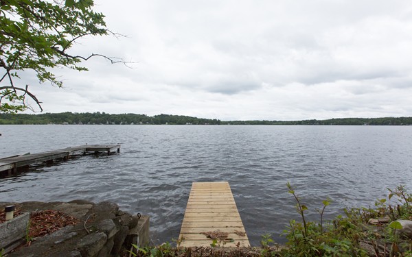 89 Lake Attitash Road Amesbury, MA 01913 - Photo 4 of 29 a view of a lake from a yard