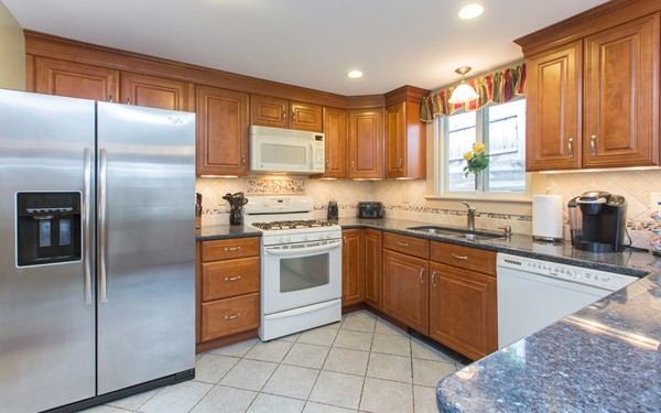 89 Lake Attitash Road Amesbury, MA 01913 - Photo 5 of 29 a kitchen with stainless steel appliances granite countertop a refrigerator and a stove top oven