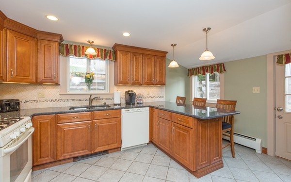 89 Lake Attitash Road Amesbury, MA 01913 - Photo 6 of 29 a kitchen with a sink window and cabinets