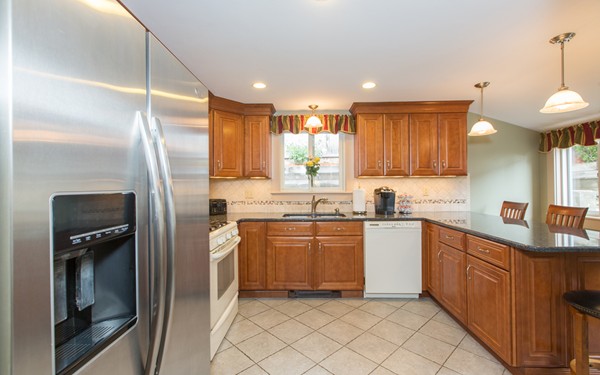 89 Lake Attitash Road Amesbury, MA 01913 - Photo 7 of 29 a kitchen with a sink stainless steel appliances and cabinets