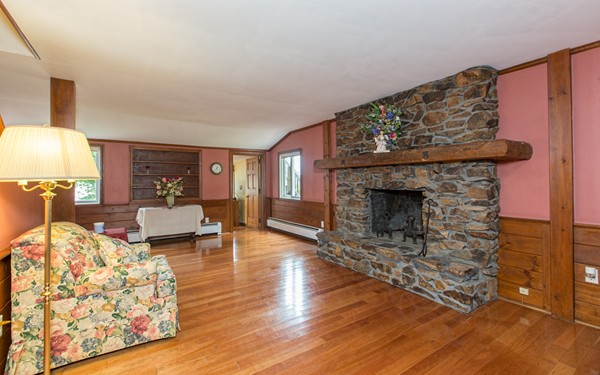 89 Lake Attitash Road Amesbury, MA 01913 - Photo 8 of 29 a living room with furniture and a fireplace