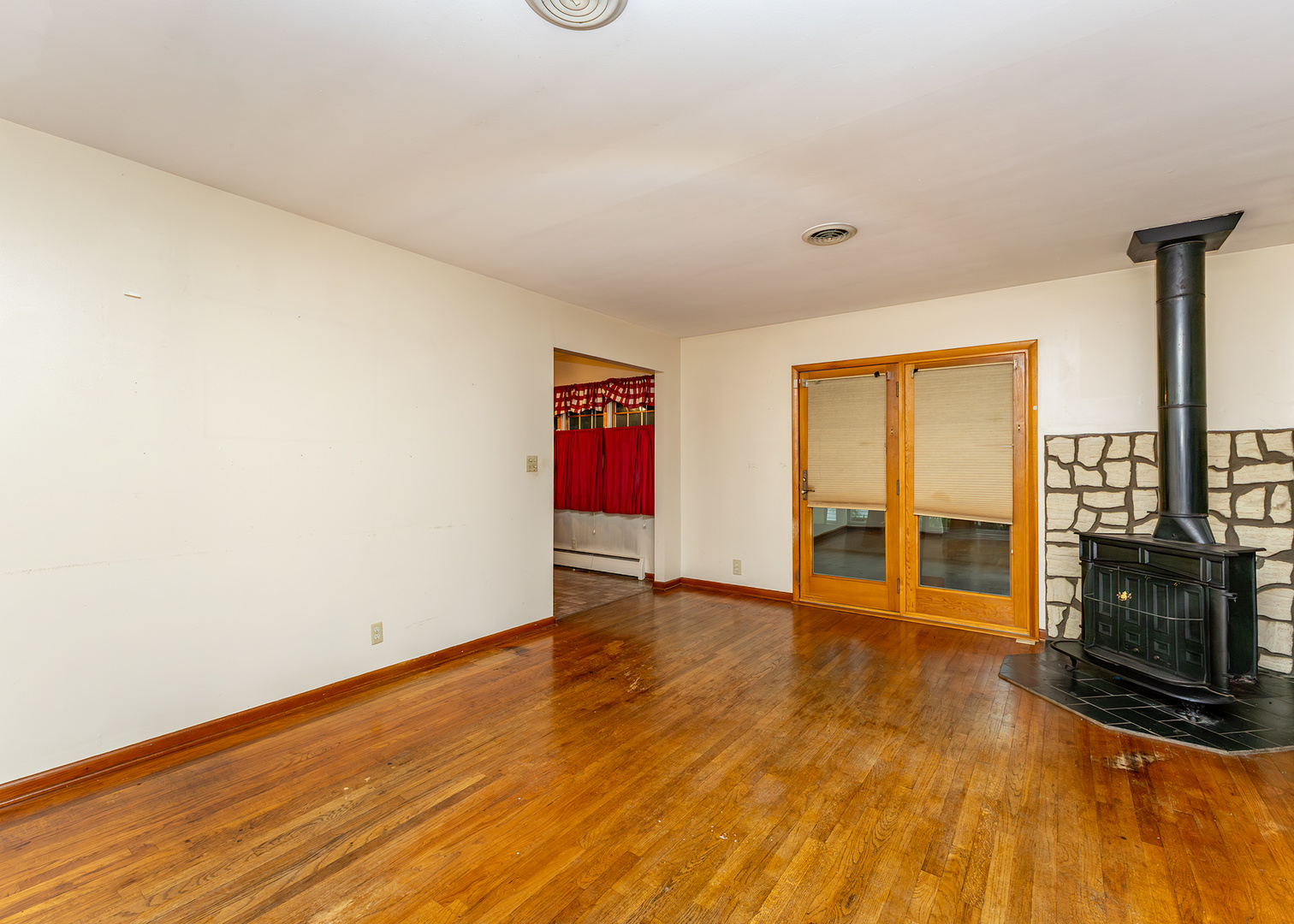1608 3rd Street Camanche, IA 52730 - Photo 5 of 25 a view of an empty room with wooden floor and a fireplace