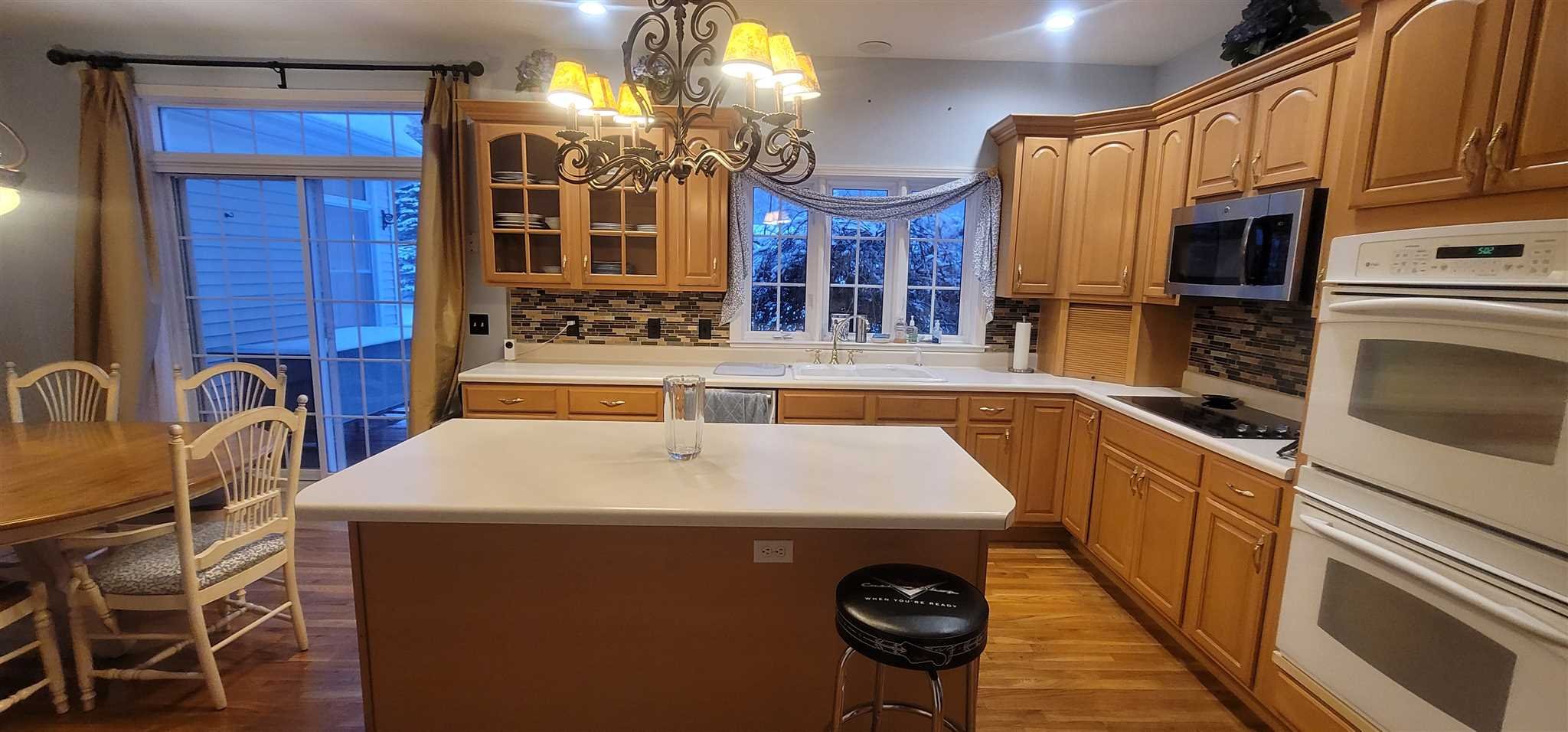 39 Brookside Lane Lagrangeville, NY 12540 - Photo 11 of 30 a kitchen with a sink a kitchen island a stove and a refrigerator