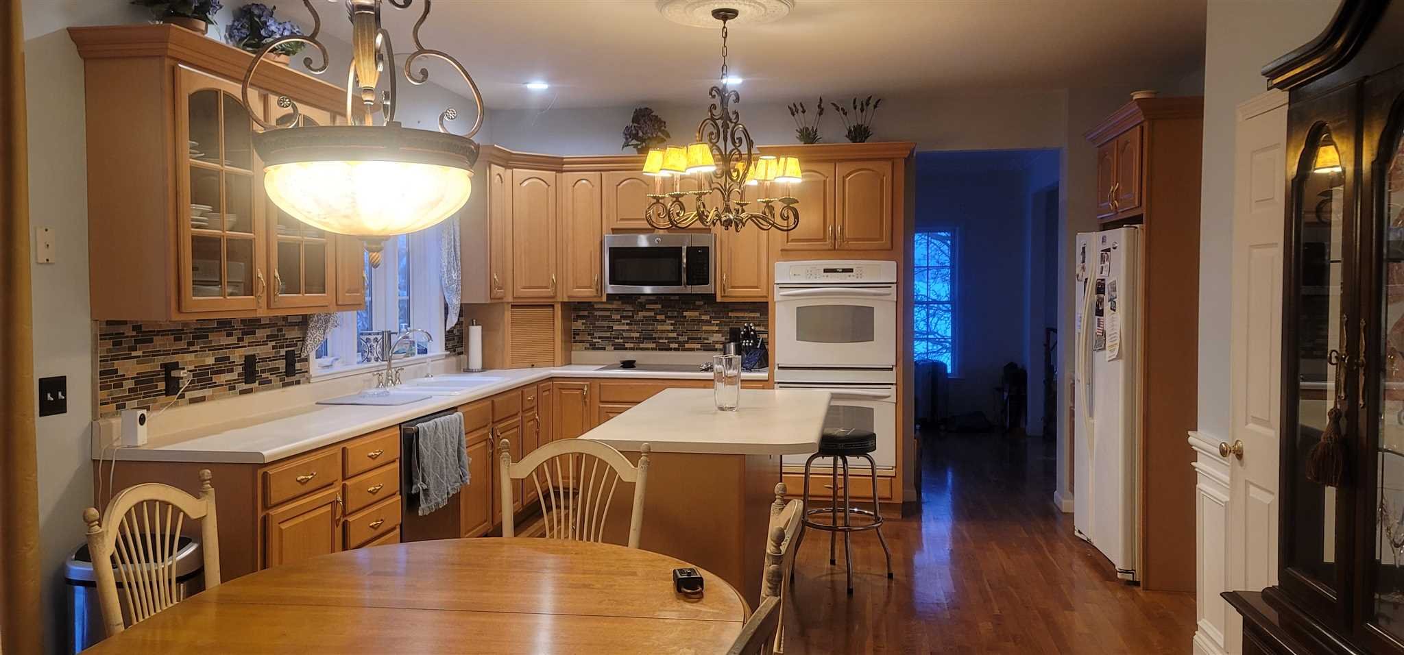 39 Brookside Lane Lagrangeville, NY 12540 - Photo 13 of 30 a view of a kitchen from a dining room with a table and chairs