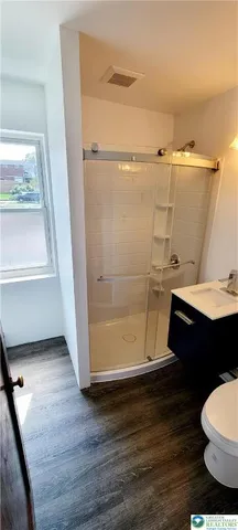 a bathroom with a sink mirror vanity and toilet