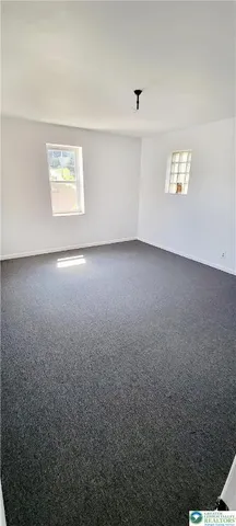 a view of an empty room and a window