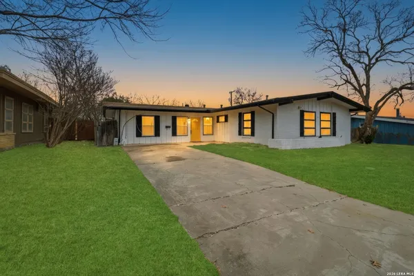 a front view of house with yard and green space
