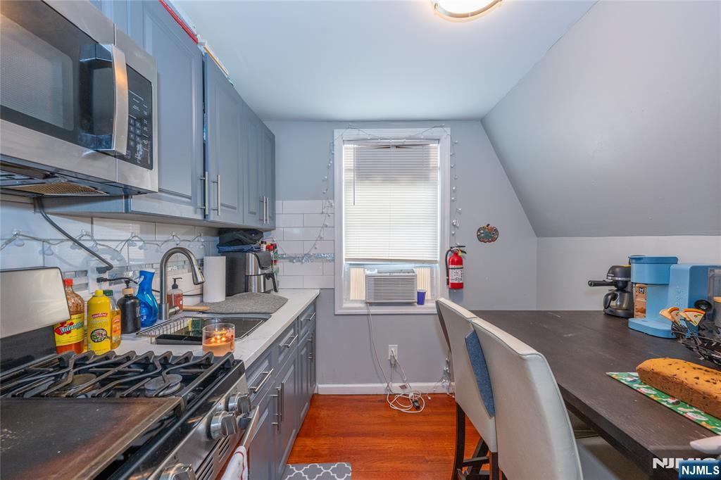 65 Grove Street Bloomfield, NJ 07003 - Photo 17 of 50 a kitchen with stainless steel appliances granite countertop a stove and a sink