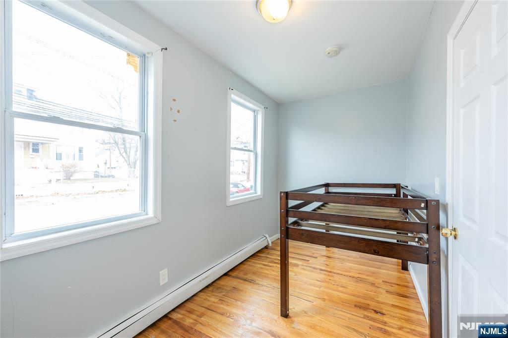 65 Grove Street Bloomfield, NJ 07003 - Photo 26 of 50 a bedroom with a bed and a window