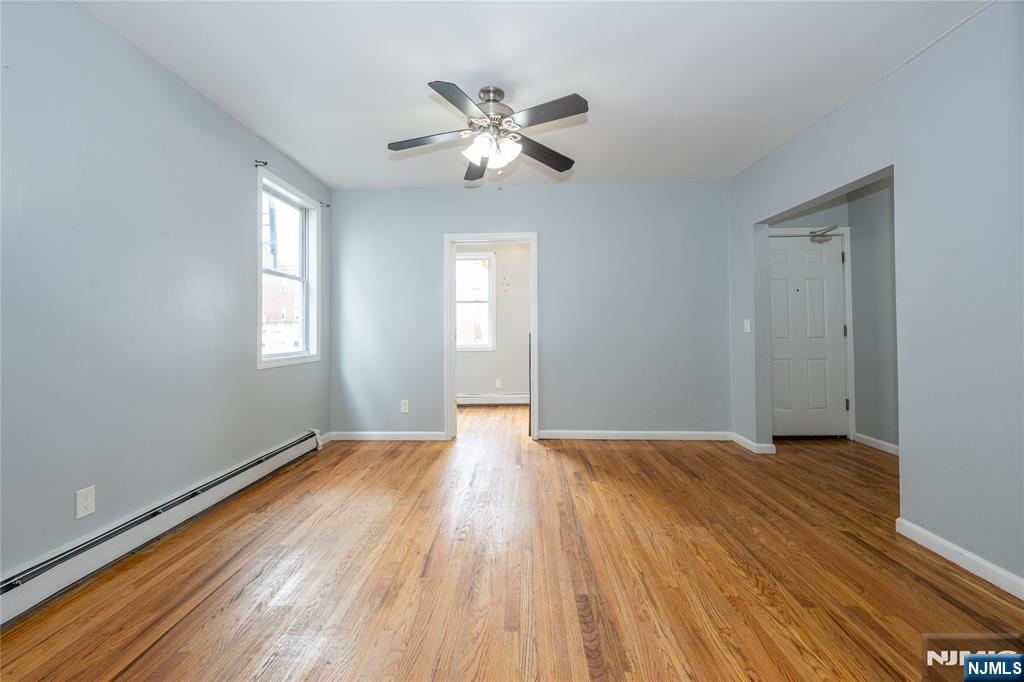 65 Grove Street Bloomfield, NJ 07003 - Photo 29 of 50 a view of an empty room with wooden floor and a window