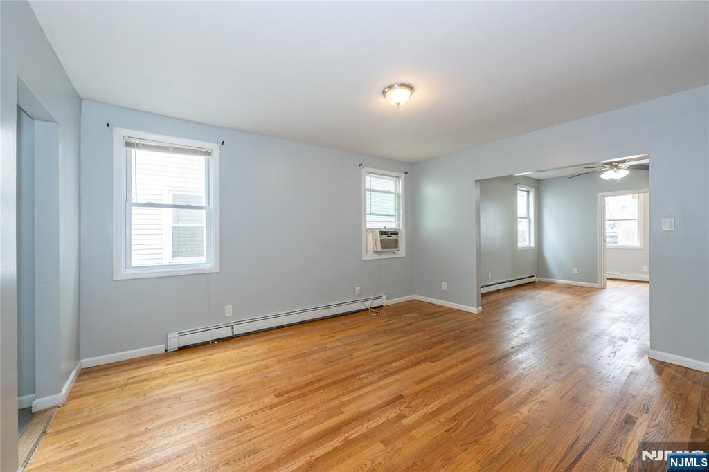 65 Grove Street Bloomfield, NJ 07003 - Photo 31 of 50 a view of an empty room with wooden floor and a window