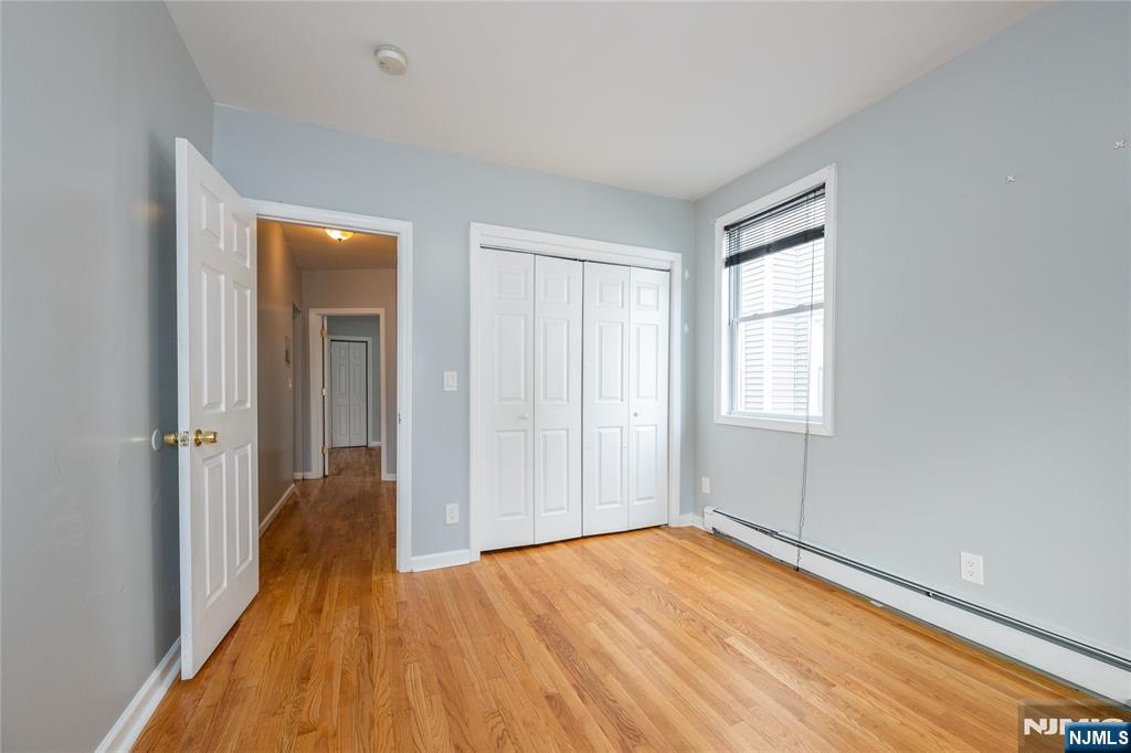 65 Grove Street Bloomfield, NJ 07003 - Photo 37 of 50 wooden floor in an empty room with a window