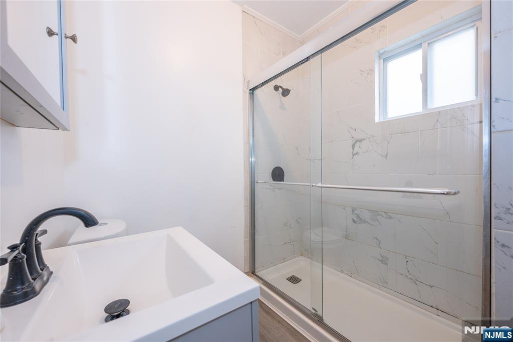 65 Grove Street Bloomfield, NJ 07003 - Photo 39 of 50 a bathroom with a sink and a shower