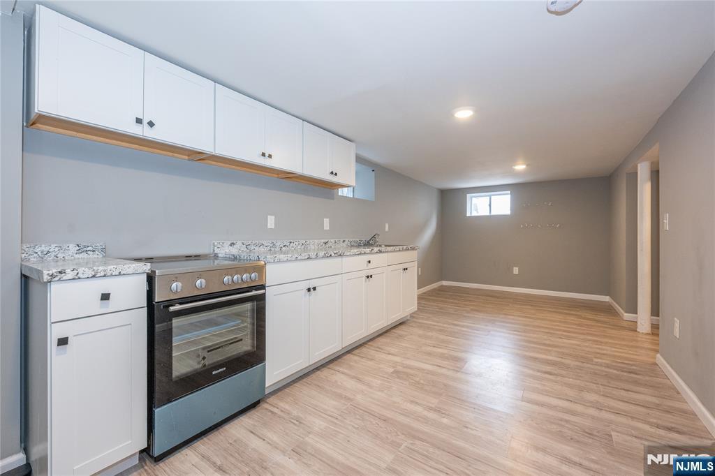 65 Grove Street Bloomfield, NJ 07003 - Photo 42 of 50 a kitchen with granite countertop white cabinets and white appliances