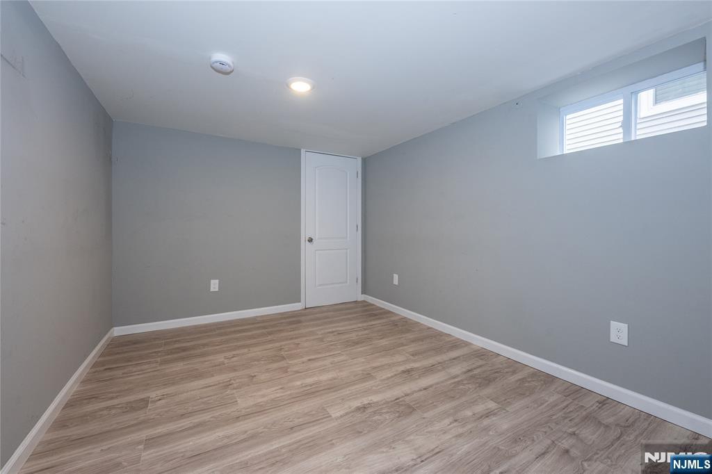 65 Grove Street Bloomfield, NJ 07003 - Photo 45 of 50 a view of an empty room with wooden floor and a window