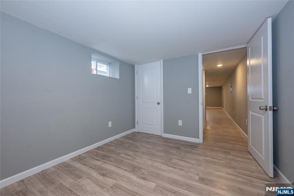 65 Grove Street Bloomfield, NJ 07003 - Photo 46 of 50 a view of an empty room with wooden floor and a bathroom