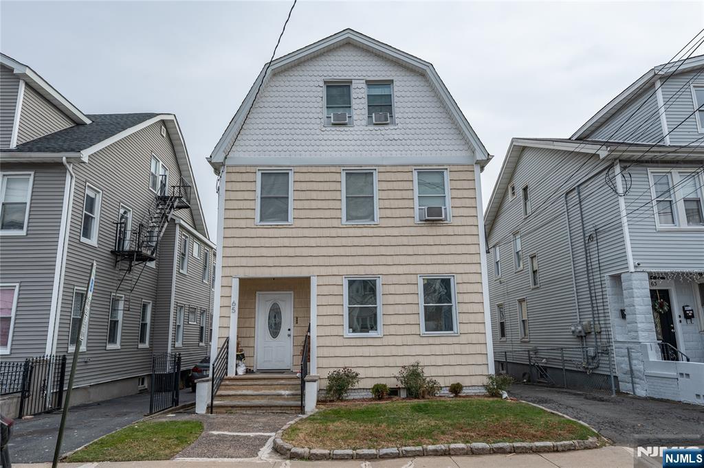 65 Grove Street Bloomfield, NJ 07003 - Photo 48 of 50 a front view of a house with a yard